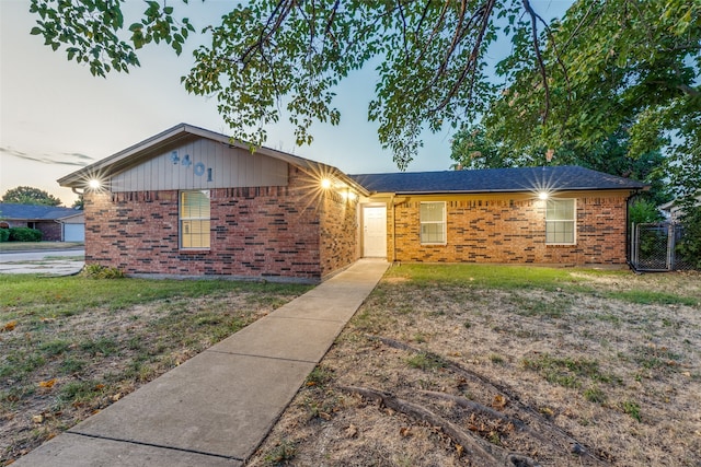 ranch-style home with a lawn