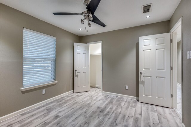 unfurnished bedroom with ceiling fan and light hardwood / wood-style floors