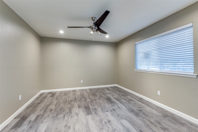 empty room featuring wood-type flooring and ceiling fan