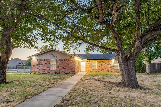 ranch-style home with a lawn