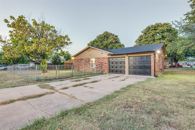 view of front of home featuring a garage and a front lawn