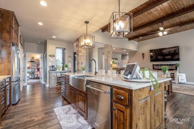 kitchen with hanging light fixtures, wooden ceiling, beamed ceiling, a kitchen island with sink, and appliances with stainless steel finishes