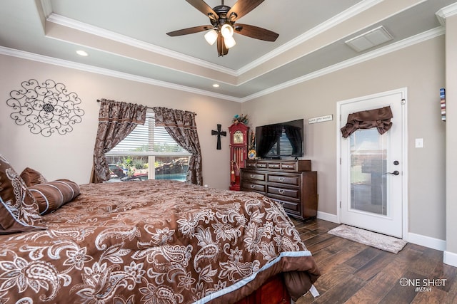 bedroom featuring dark wood-type flooring, a raised ceiling, ceiling fan, and crown molding