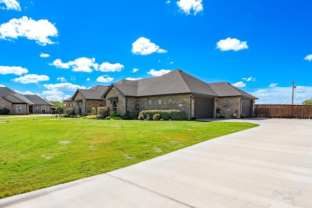 french country inspired facade featuring a front yard and a garage