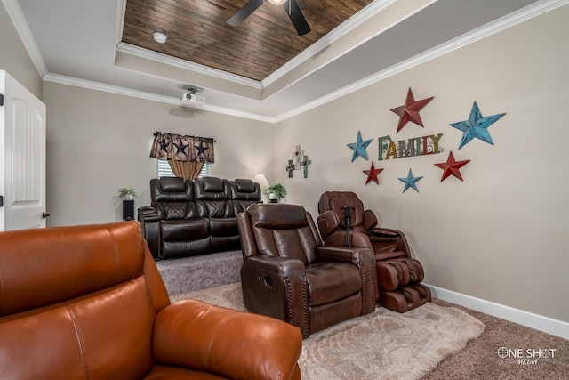 carpeted cinema with ornamental molding, a raised ceiling, ceiling fan, and wooden ceiling