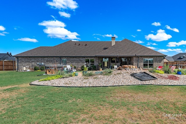 rear view of house featuring a yard