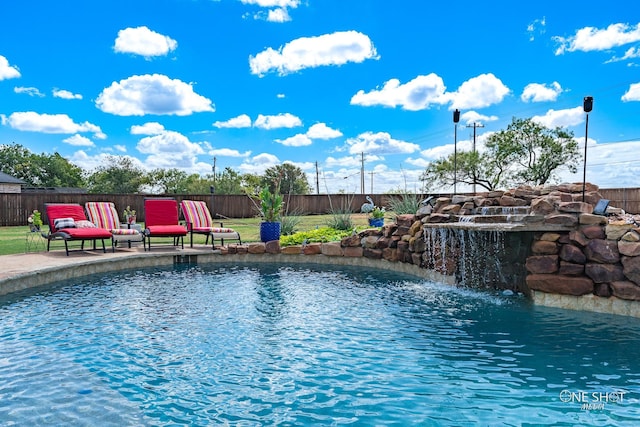 view of swimming pool with pool water feature