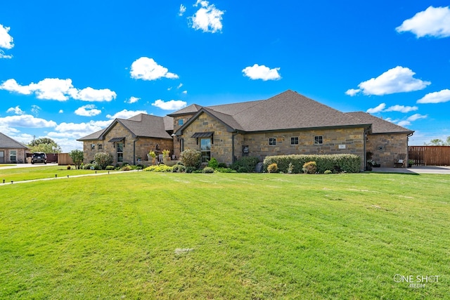 french country inspired facade featuring a front lawn