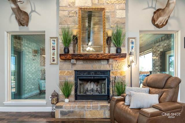 sitting room with a fireplace and hardwood / wood-style floors