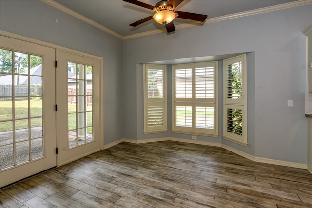 interior space with ceiling fan, ornamental molding, and wood-type flooring