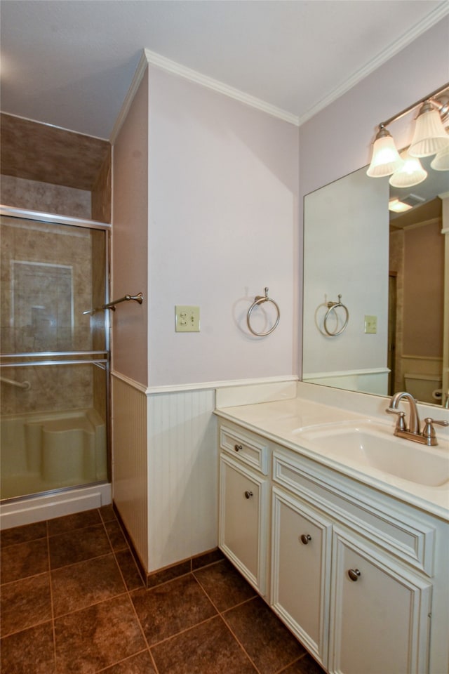 bathroom featuring ornamental molding, vanity, a shower with shower door, and tile patterned flooring