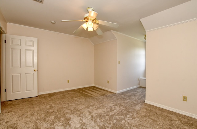 unfurnished room with lofted ceiling, crown molding, ceiling fan, and light carpet