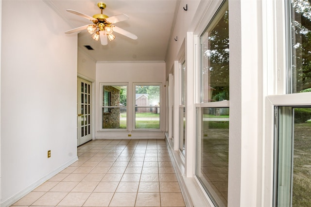 unfurnished sunroom with ceiling fan