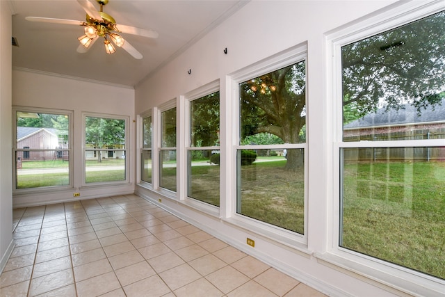 unfurnished sunroom featuring ceiling fan