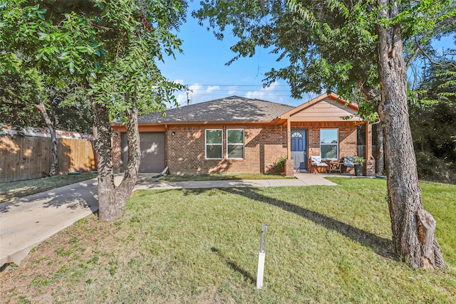 single story home featuring a garage and a front yard