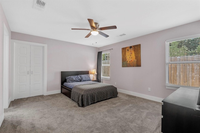 bedroom featuring light carpet, visible vents, and baseboards