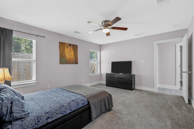 bedroom featuring multiple windows, visible vents, and light colored carpet