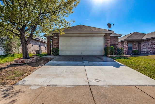 ranch-style home featuring central air condition unit, a garage, and a front lawn