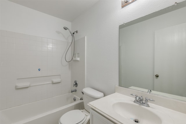 full bathroom featuring tiled shower / bath, vanity, and toilet