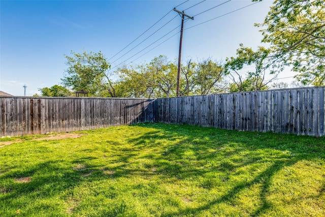 view of yard with a fenced backyard