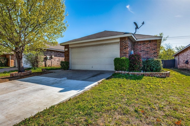 exterior space featuring concrete driveway, an attached garage, fence, a yard, and brick siding