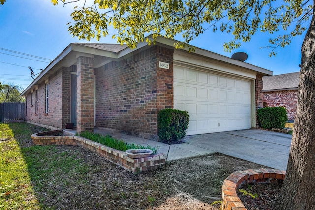 view of property exterior with a garage, fence, concrete driveway, and brick siding