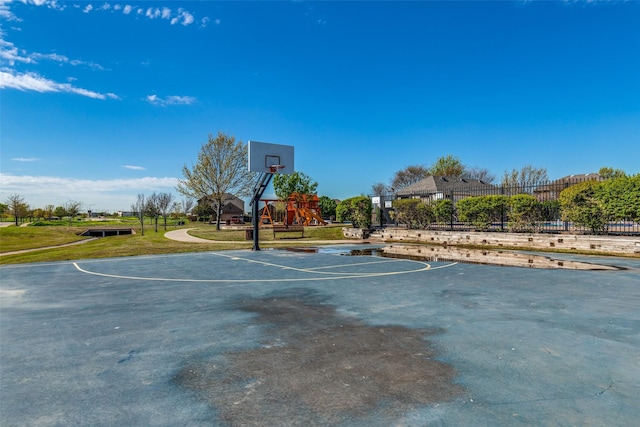 view of basketball court with community basketball court, a yard, playground community, and fence