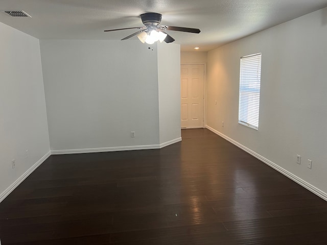 unfurnished room featuring ceiling fan and dark hardwood / wood-style floors