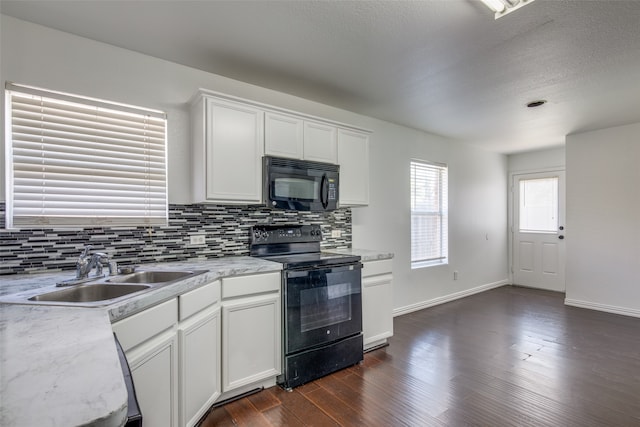 kitchen with black appliances, tasteful backsplash, sink, and dark hardwood / wood-style floors