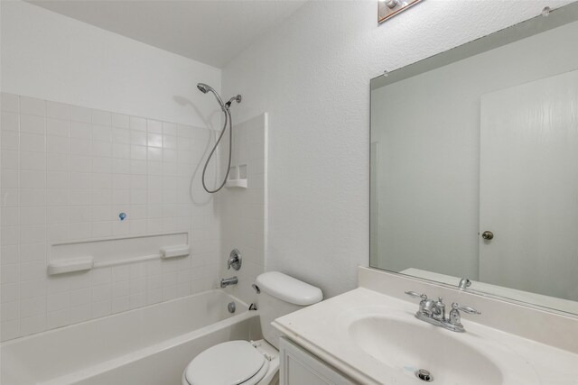 full bath featuring washtub / shower combination, vanity, and toilet