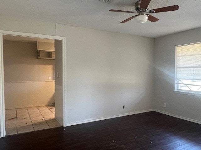 unfurnished room featuring hardwood / wood-style floors and ceiling fan