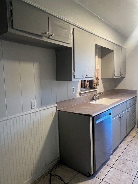 kitchen with dishwashing machine, gray cabinets, sink, and light tile patterned floors