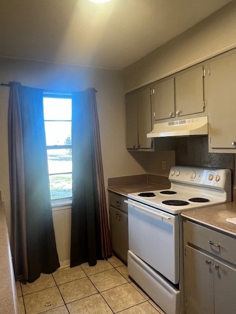 kitchen with light tile patterned floors, plenty of natural light, gray cabinetry, and white range with electric cooktop