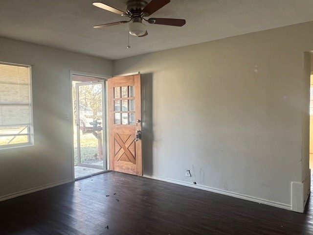 interior space with ceiling fan and dark hardwood / wood-style flooring