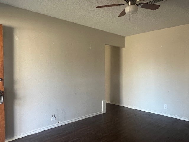 unfurnished room featuring a textured ceiling, ceiling fan, and dark hardwood / wood-style flooring