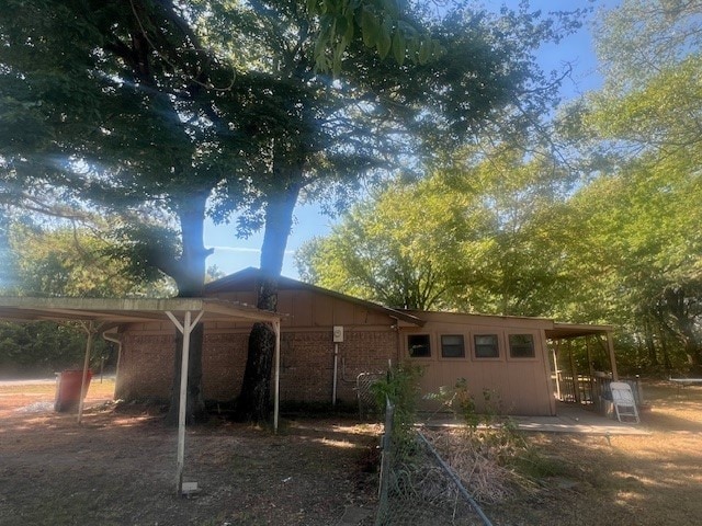 rear view of house featuring a carport