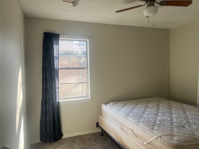 bedroom featuring ceiling fan and carpet floors