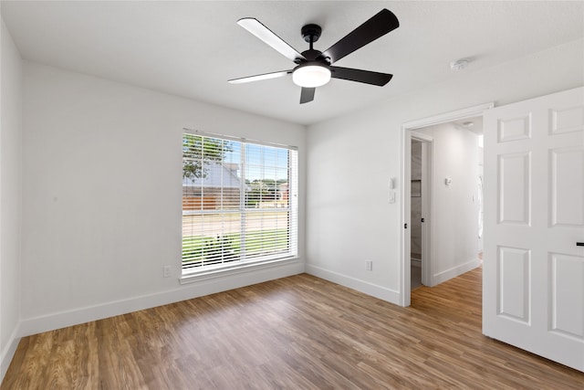 unfurnished room featuring ceiling fan and hardwood / wood-style flooring