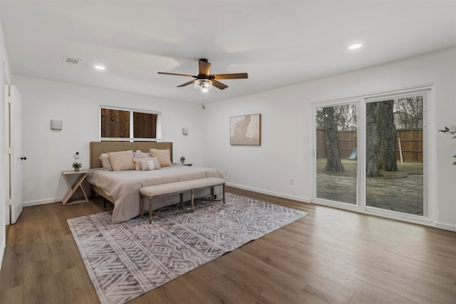 bedroom featuring ceiling fan, hardwood / wood-style flooring, and access to exterior