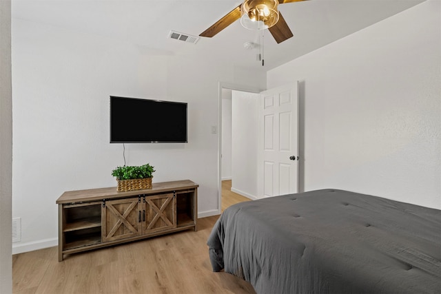 bedroom with lofted ceiling, light hardwood / wood-style flooring, and ceiling fan