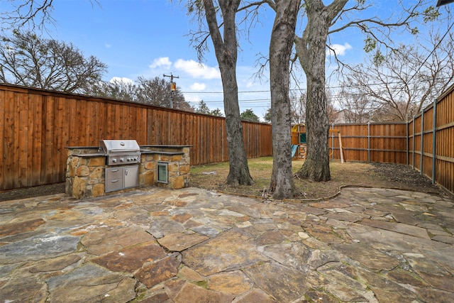 view of patio / terrace with grilling area and an outdoor kitchen