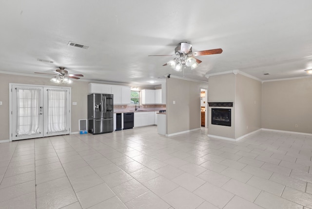 unfurnished living room featuring ornamental molding, french doors, ceiling fan, and light tile patterned flooring