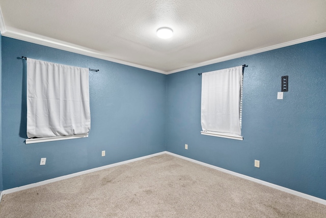 unfurnished room with a textured ceiling, carpet, and ornamental molding