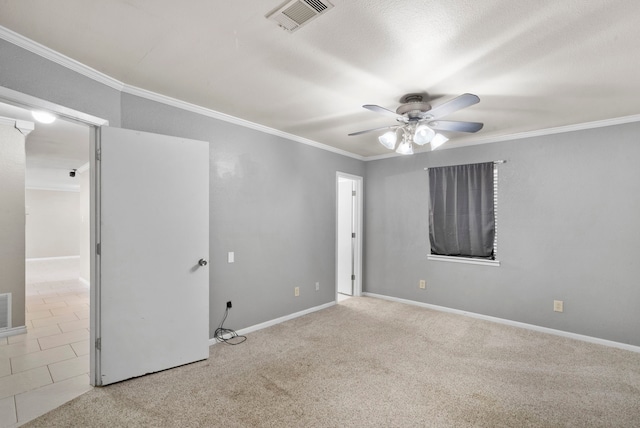 unfurnished room featuring ceiling fan, crown molding, and light tile patterned flooring