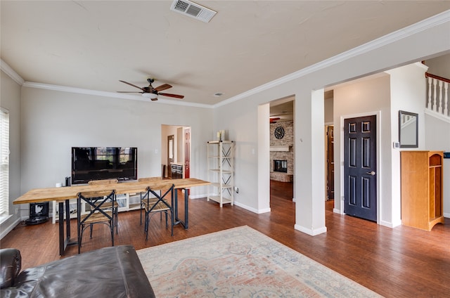 office featuring ornamental molding, dark hardwood / wood-style flooring, a fireplace, and ceiling fan