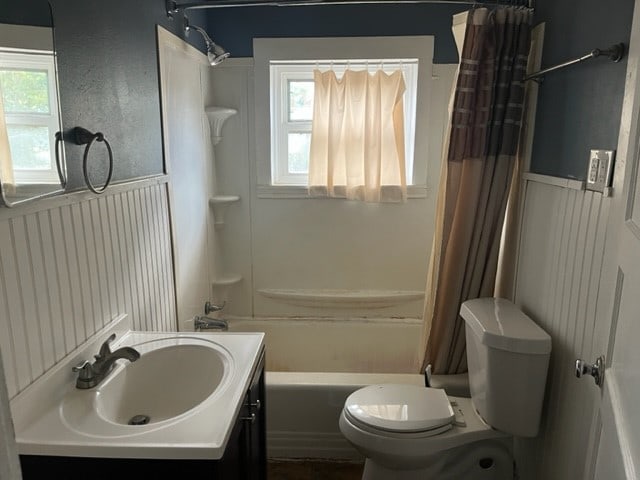 full bathroom featuring vanity, toilet, a wealth of natural light, and shower / tub combo