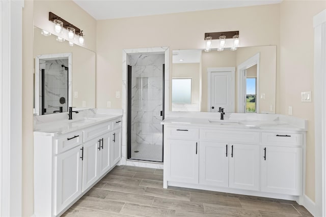 bathroom with a marble finish shower, wood tiled floor, and a sink