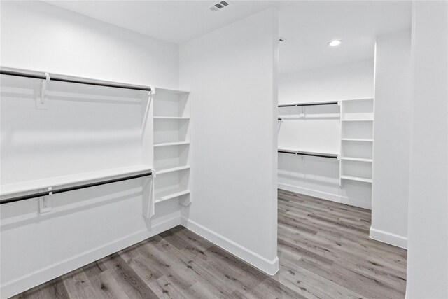 walk in closet featuring visible vents and wood finished floors