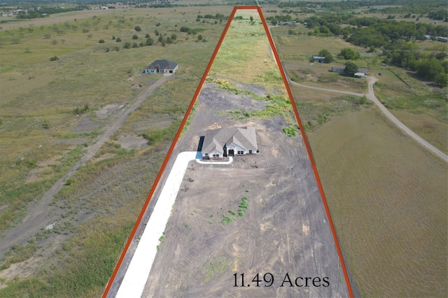 birds eye view of property with a rural view