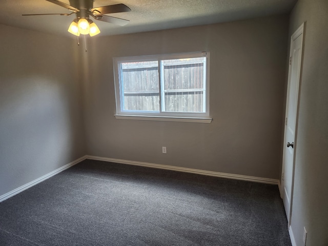 carpeted spare room with a textured ceiling and ceiling fan